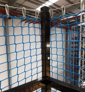A close-up photo of the corner of a mezzanine handrail, secured using handrail netting