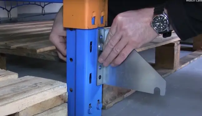 Close-up photo showing someone fitting the bottom intermediary bracket.