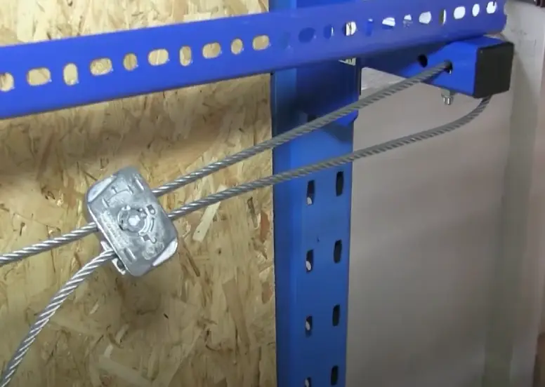 Close-up showing the placement of the cable fixer on a back-of-rack netting system.