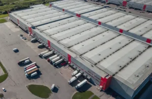 Aerial view of a large distribution centre, with HGVs parked outside loading bays.